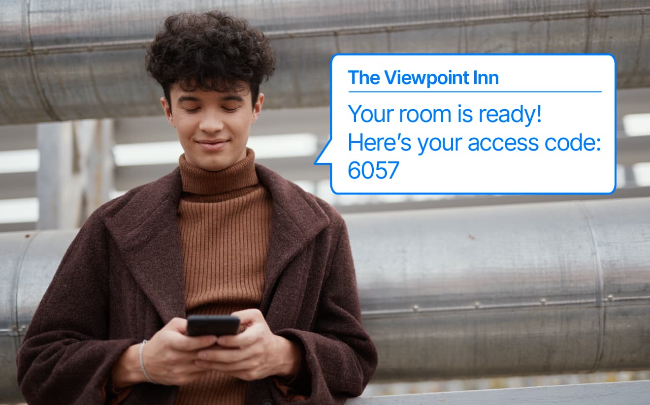A person receiving a room-ready notification via text message from The Viewpoint Inn, with access code.