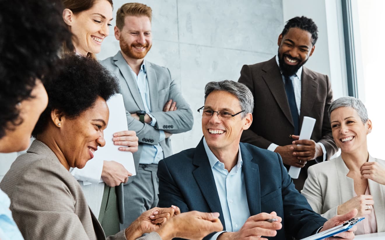 A group of professionals in a meeting, discussing reports and strategies to keep property owners informed and happy with their vacation rental management.