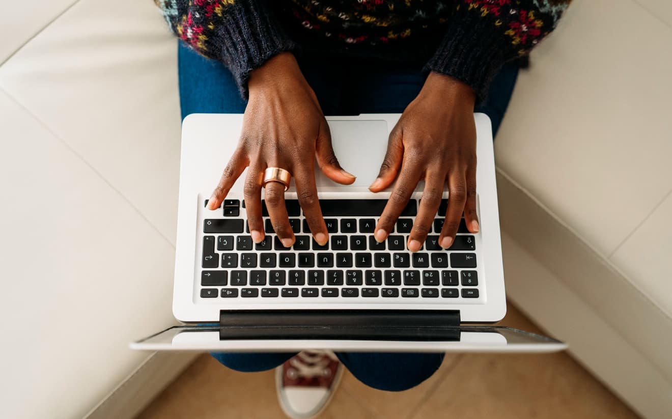 A close-up of hands typing on a laptop, highlighting content writing services that craft compelling narratives to showcase property features and drive bookings and guest loyalty.