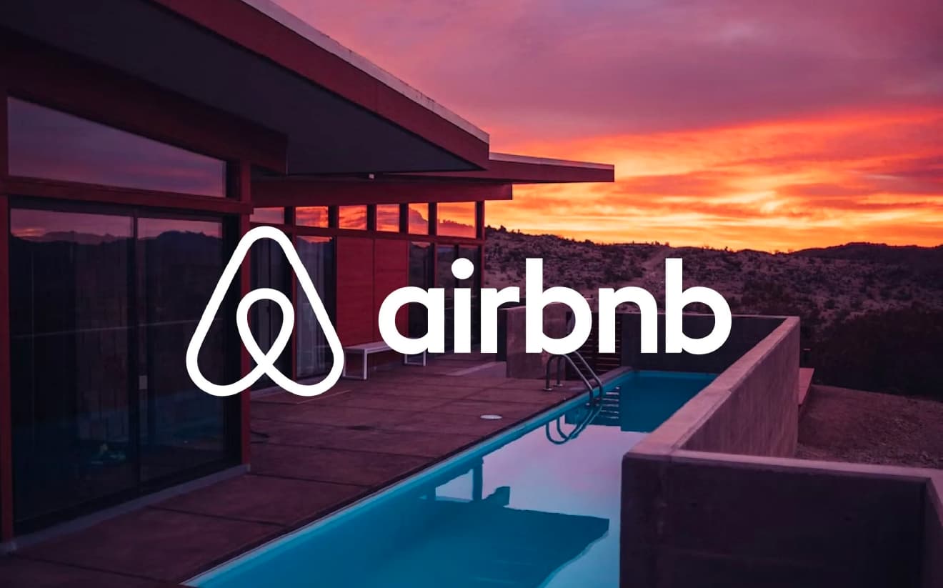 A property with a pool at sunset, featuring the Airbnb logo in the foreground.