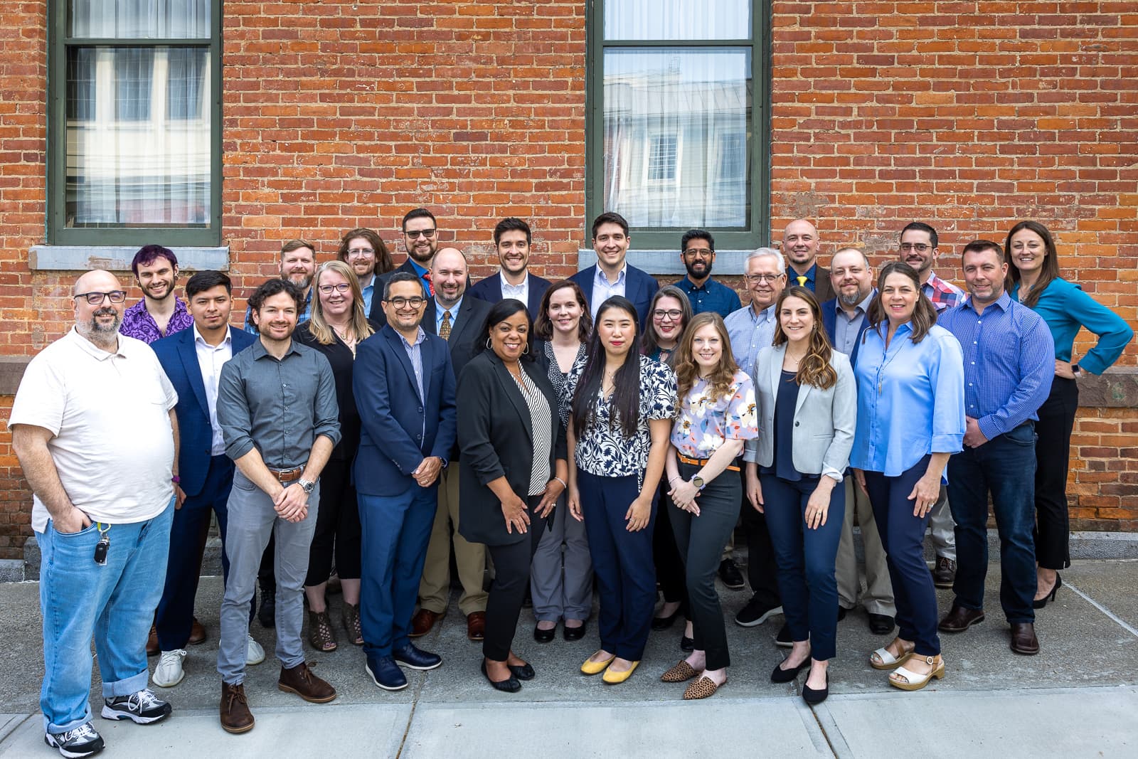 ThinkReservations company photo, all team members standing outside a hotel