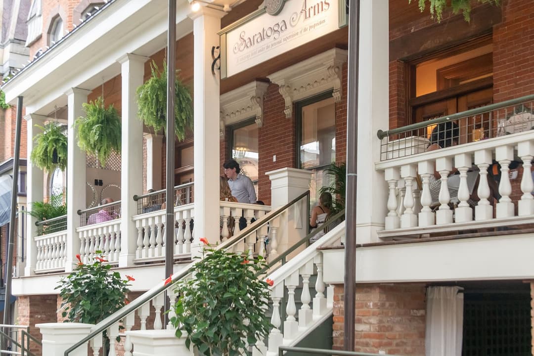 Saratoga Arms front porch full of guests