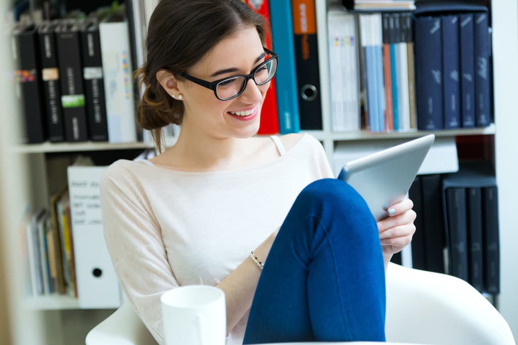A female traveler books a hotel room using a tablet