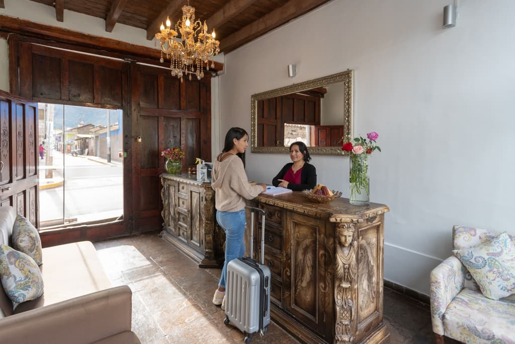 A female travelers checks into a boutique hotel front desk