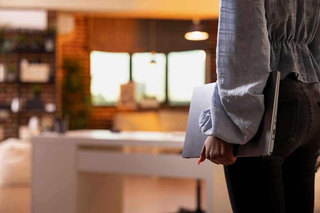 Hotelier carrying her computer in the front desk area