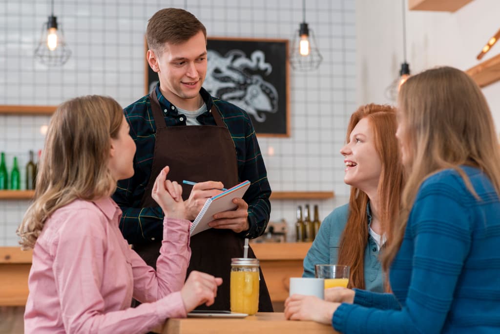A staff member takes care of the orders for guests in an property coffee shop