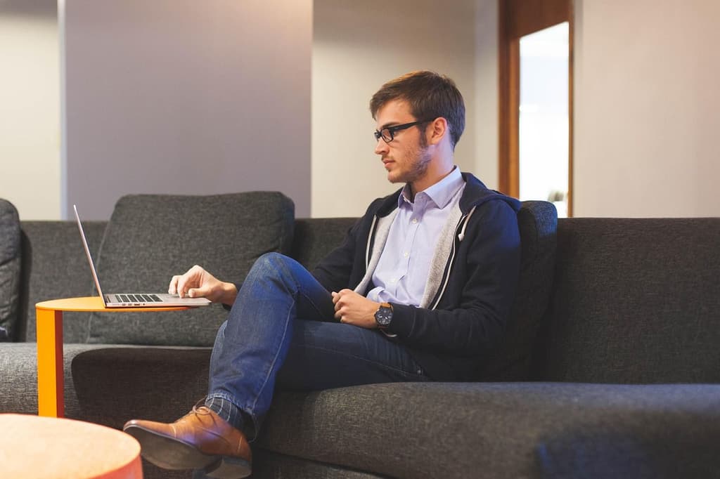 Business traveler working on his computer in a hotel lobby