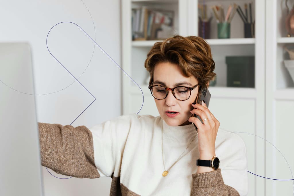 Female talking on the phone in front of computer