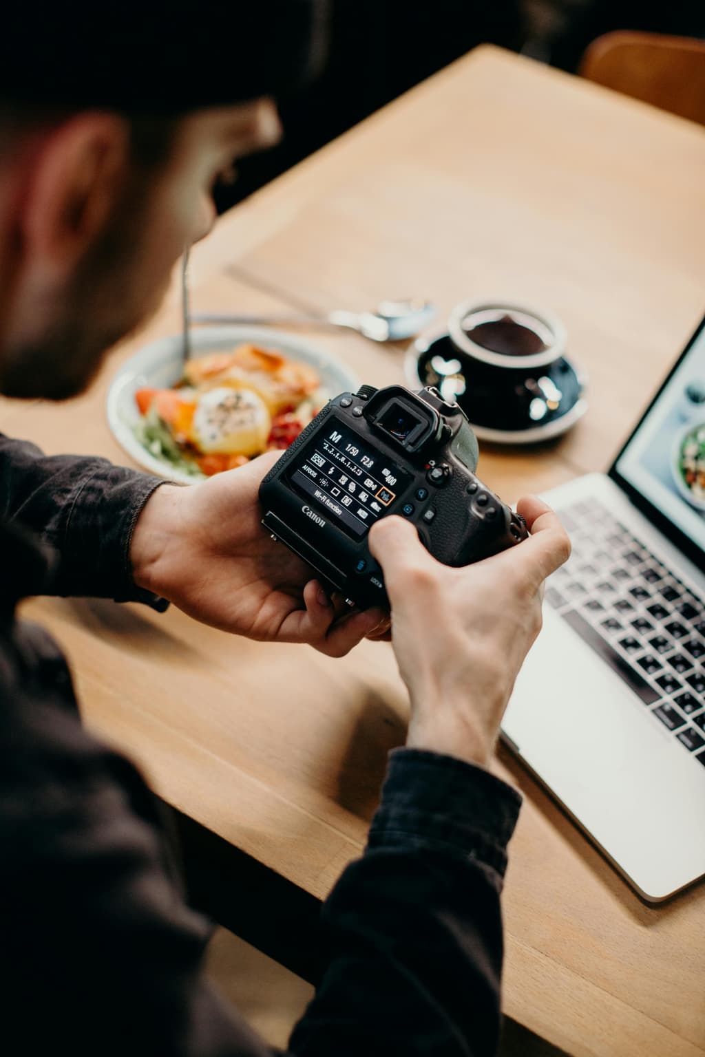 A photographer modifying his camera settings