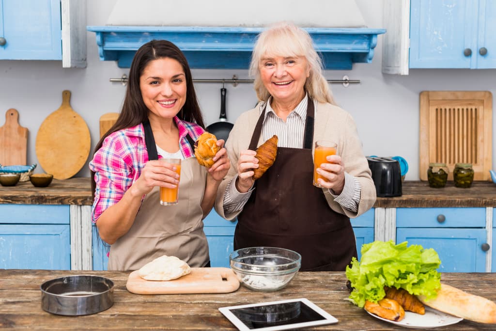 Happy innkeepers working together in the kitchen