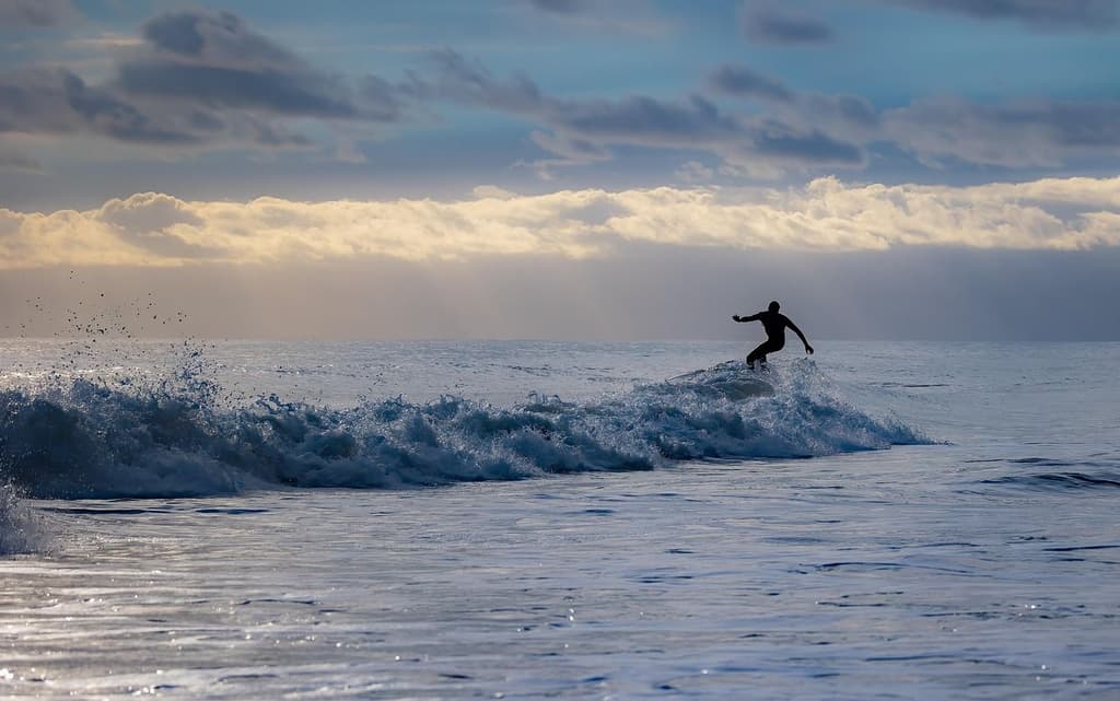 Surfer riding a wave on the beach