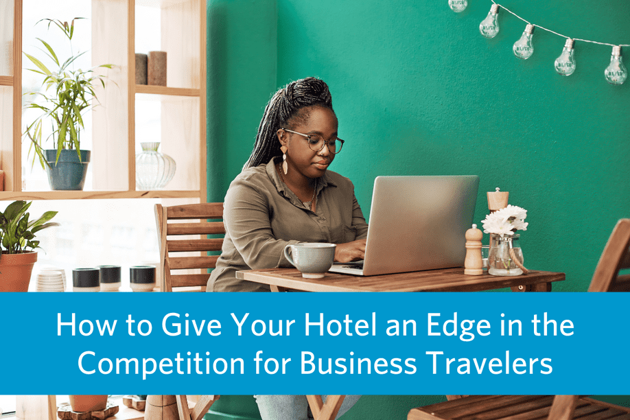 a woman sitting in a restaurant working on a laptop with article title text overlay: How to Give Your Hotel an Edge in the Competition for Business Travelers