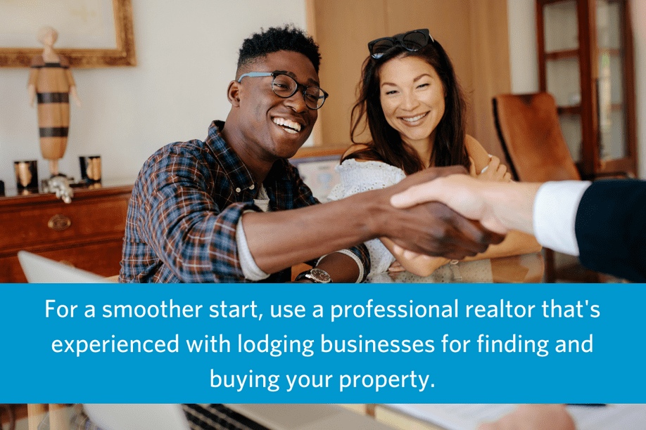 a couple sitting at a desk shaking hands with someone on the other side with text overlay that reads For a smoother start, use a professional realtor that's experienced with lodging businesses for finding and buying your property.